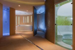 a bathroom with a tub and a glass door at Apartamenty AquaMarina in Świnoujście +19 photos