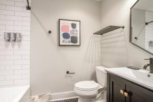 a white bathroom with a toilet and a sink at Bright Bungalow Country Dream Retreat in Franklin +24 photos