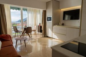 a living room with a couch and a table with chairs at Vista Azul Sea View Apartment with Free Parking Calpe in Ifach