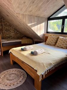 a bedroom with a bed with two pillows on it at Kaimukas - lake house for 15 persons 5 bedrooms in Dvarčėnai