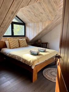 a bedroom with a large bed in a attic at Kaimukas - lake house for 15 persons 5 bedrooms in Dvarčėnai