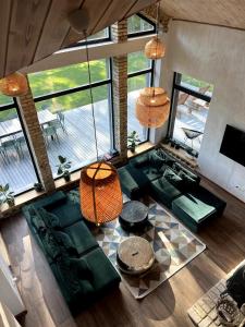 an overhead view of a living room with green furniture at Kaimukas - lake house for 15 persons 5 bedrooms in Dvarčėnai