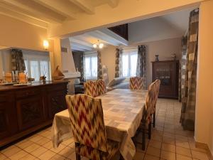a kitchen and dining room with a table and chairs at Villa Nina in Besse-et-Saint-Anastaise