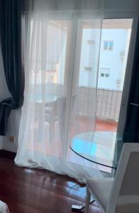 a room with a window with a table and a chair at Altea Beach in Altea