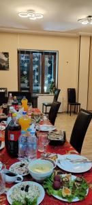 a long table with plates of food on it at Hotel Svanseti in Mestia