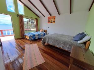 a bedroom with a bed and a large window at Palacio del Inca Lodge in Comunidad Yumani