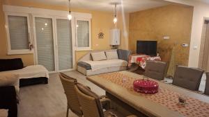 a living room with a couch and a table at Villa Sunset in Banja Luka