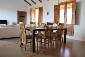 a dining room table with chairs and a couch at Embeleso - Yaiza in Yaiza