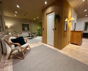 a living room with a wicker chair and a door at Villa Luna with jacuzzi in Rovaniemi