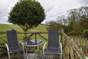 a table and chairs sitting on a wooden deck at Frogwell in Strete