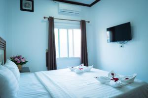 Postel nebo postele na pokoji v ubytování Vientiane Ruby Riverside Hotel