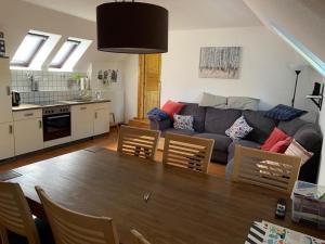 a living room with a couch and a table at Boardinghouse Südbrookmerland in Südbrookmerland
