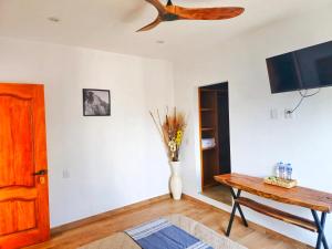 a living room with a vase of flowers and a table at Casa Flores in Tepoztlán