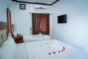 Postel nebo postele na pokoji v ubytování Vientiane Ruby Riverside Hotel