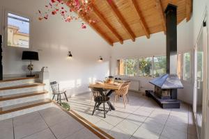 a kitchen and dining room with a table and a stove at SeaHomes Vacations - Rustic Villa Escape in Tordera