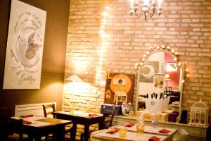 a dining room with two tables and a mirror at Locanda Alla Mano in Forlimpopoli