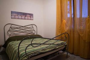a bed in a room next to a window at B&B River in Ascoli Piceno