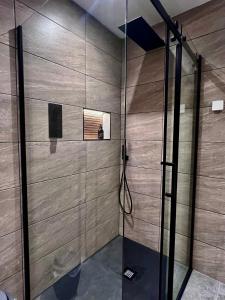 a shower with a glass door in a bathroom at Luxury 3 Bedroom House - Stag Moor House in Portree