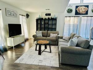 a living room with two couches and a tv at The House of Serenity: Close to Fort Sill & Casino in Lawton