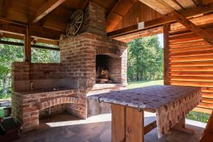 an outdoor kitchen with a brick oven in a pavilion at Mountain Hut Stara Hiša in Kupjak