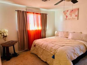 a bedroom with a bed and a window at The House of Serenity: Close to Fort Sill & Casino in Lawton +94 photos