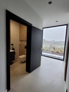 an open door to a bathroom with a toilet at Ostatni dom po lewej in Białe Błoto +12 photos