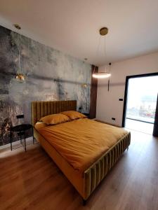 a bedroom with a large bed and a large window at Ostatni dom po lewej in Białe Błoto