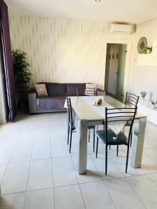 a table and chairs in a living room with a couch at Casa Mia in LʼAnnunziata