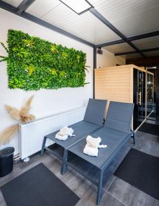 a patio with two chairs and a table with towels at Kuća za odmor Natur in Brežane Lekeničke