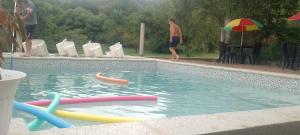 a swimming pool with many colorful inflatables in it at CerroMio! in Villa Serranita