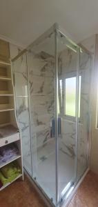 a shower in a room with a glass enclosure at Casa El Acebo in Muros de Nalón