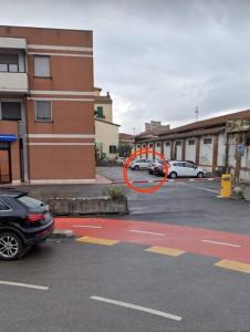 a car parked in a parking lot next to a building at Le Petit Nottolini in Lucca +11 photos