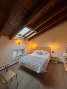 a bedroom with a large bed and a skylight at Fábrica de Harinas La Gloria in San Millán de la Cogolla