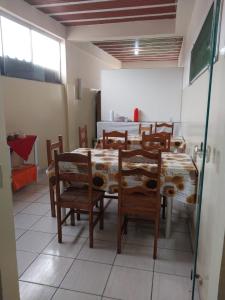 a dining room with a table and chairs in a room at Pousada Amigo João in Barão de Cocais