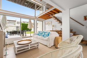 a living room with a white couch and chairs at Villa Oliveira in Sesimbra +17 photos