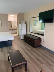 a hotel room with a bed and a large mirror at Security Inn and Suites in Lake City