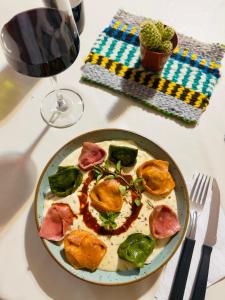 a plate of food on a table with a glass of wine at Hotel Valle Colorado in Villa Unión
