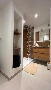 ベラックにあるStudio cosy idéal pour Séjours Courts ou Longsの洗面台と鏡付きの化粧台を備えたバスルーム +2枚の写真