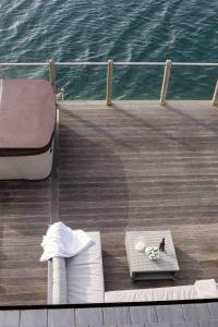 a deck of a boat with a table on the water at Summer Lake in South Cerney