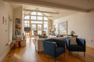 a living room with a couch and chairs at Summer Lake in South Cerney