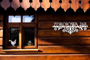 a building with a window with a cat in it at Domek Stu Wiosen - Beskid Niski in Klimkówka