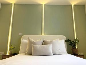 a bedroom with a white bed with lights on it at Modern two bed apartment in Hull
