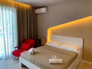 a hotel room with a bed and a red chair at The Wish Houses in Golem