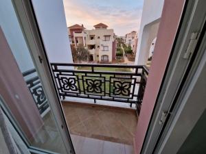 an open door to a balcony with a bench at résidence AP 2 Saidia in Saïdia