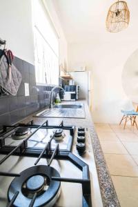 a kitchen with a stove top oven in a kitchen at Botanical Apartment Central Boho style 2 pools in Willemstad