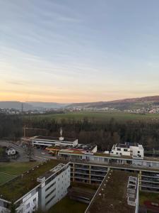 a view of a city with buildings and a field at Skyline Retreat Jedes Zimmer mit TV in Baden +39 photos