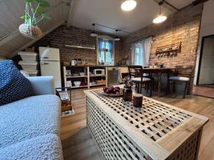 a living room with a couch and a table at Apartmány Malý Princ in Horní Blatná