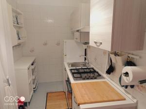 a small kitchen with a stove and a sink at La Casa di Gio ed Eli in Voghera