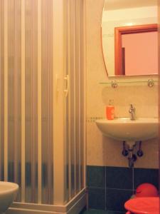 a bathroom with a sink and a mirror at Amarfia Bed & Breakfast - Your Home In Salerno in Salerno +62 photos