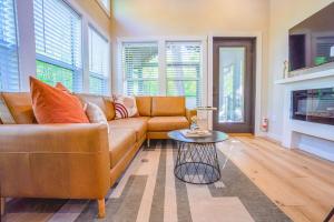 a living room with a couch and a table at Tiny home Fire Pit Fishing Pond BBQ Sage Cabin in Gatlinburg